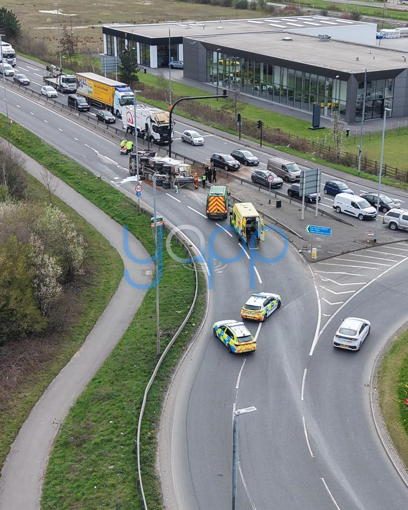 May be an image of car, road and text